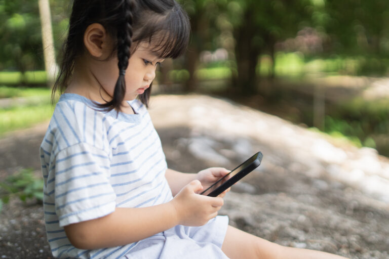 asian baby girl smiling using mobile selfie make photo picture park garden cute girl learning use smartphone by her self education learning baby concept