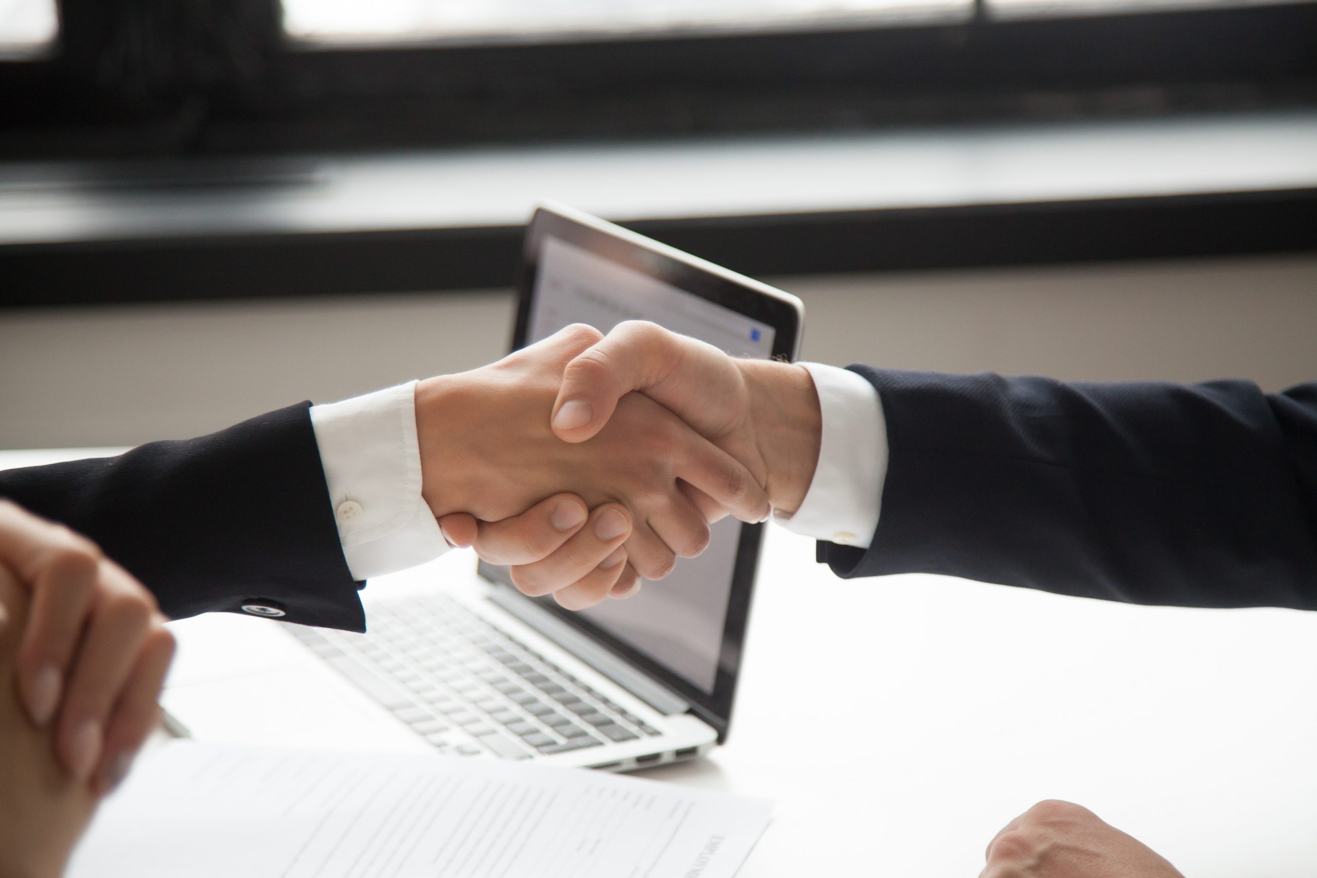 businessman handshaking businesswoman showing respect closeup view hands shaking scaled