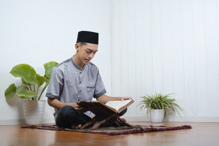 portrait young asian muslim man reading holy qur ramadan kareem home