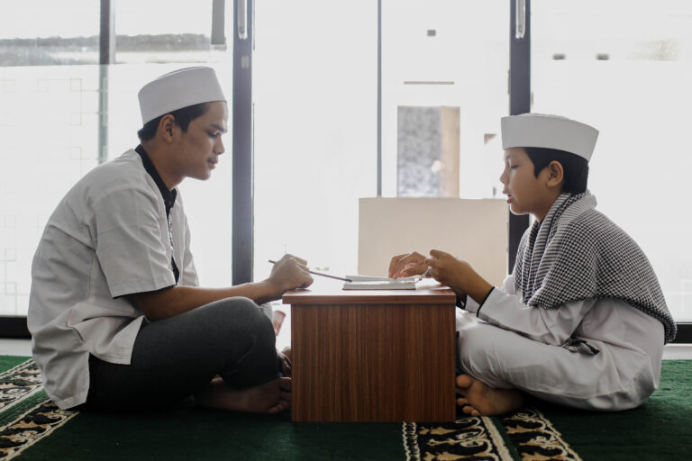 side view muslim teacher student teaching how read koran mosque