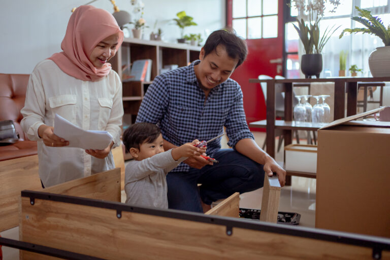 muslim family son assembling new furniture home together