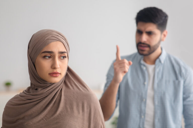 angry muslim man yelling depressed wife having conflict indoor